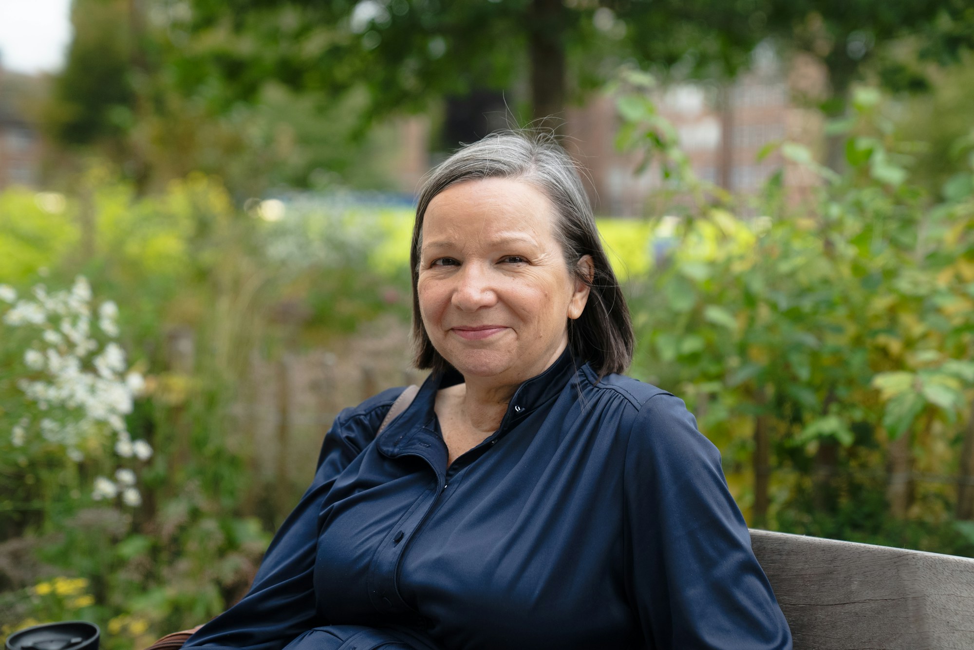 A woman smiling in a park