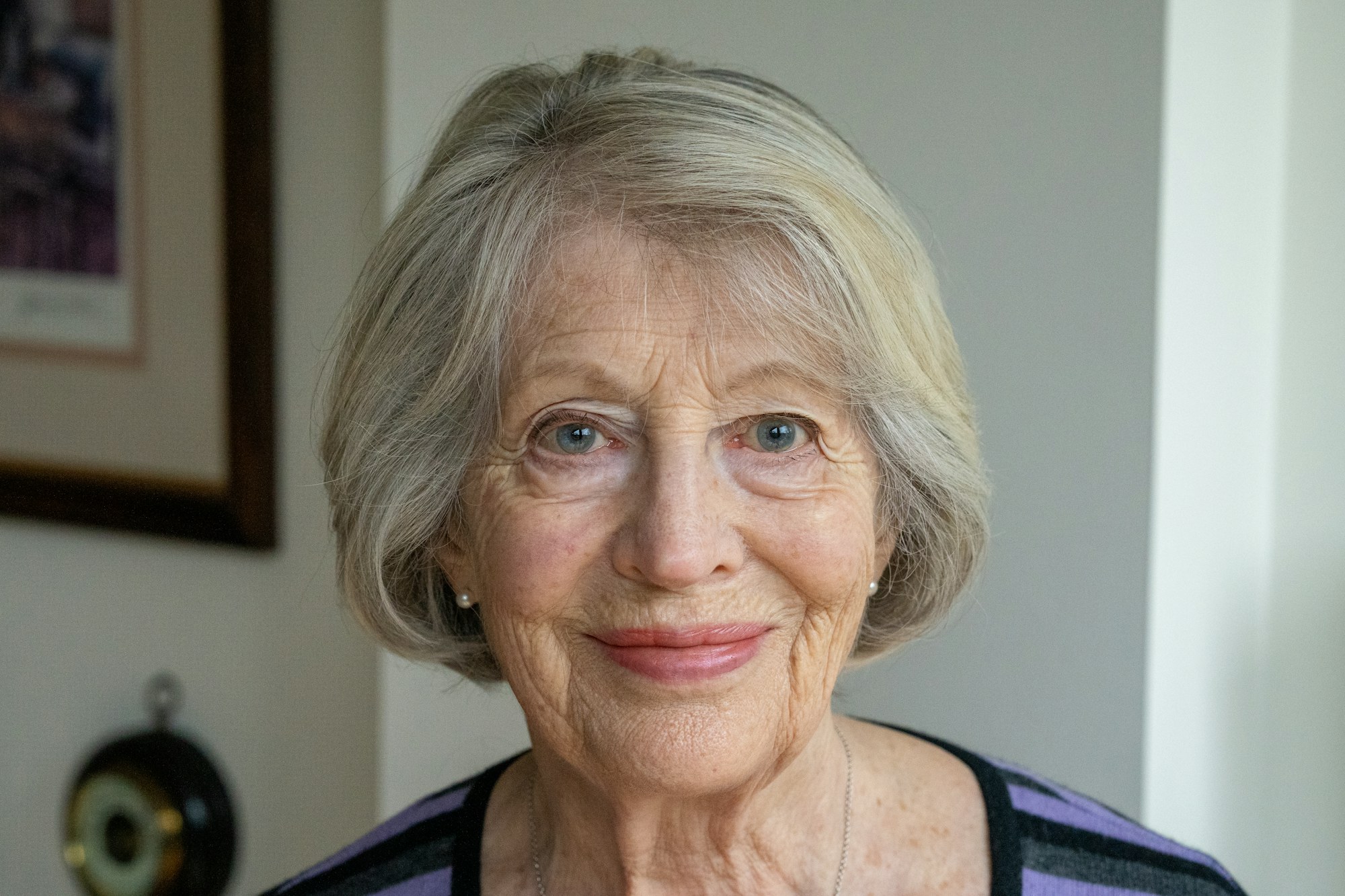 An older woman with silver hair and a warm smile